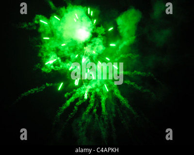 explosion of a single green firework rocket with smoke Stock Photo
