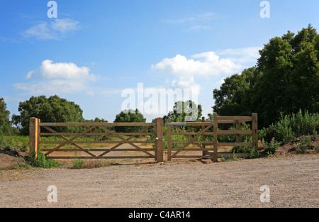 A five bar gate and kissing gate at the entrance to heathland in North Norfolk, England, United Kingdom. Stock Photo