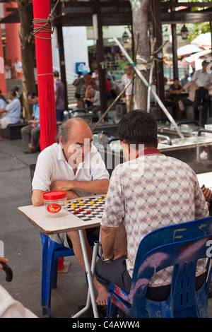 Singapore, Singapore, Chinatown. Men playing Xiangqi (Chinese chess). Stock Photo