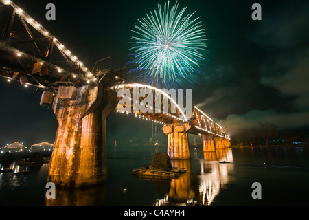 Thailand, Kanchanaburi, Kanchanaburi.  Fireworks over Death Railway Bridge (also known as 'Bridge over the River Kwai') Stock Photo