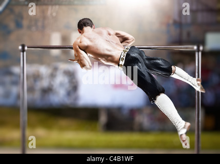 Young man doing sports exercises outdoors. Stock Photo