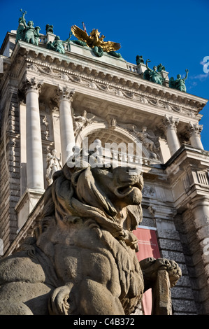 stone lion sculpture guarding vienna's national library Stock Photo