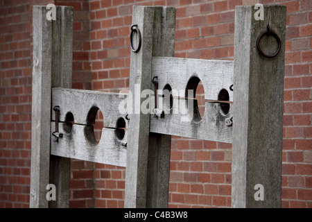 Medieval wooden stocks used for punishing crime and so people could throw vegetables and other rotten food at the punished. Stock Photo