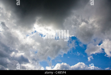 storm clouds gathering against blue sky Stock Photo