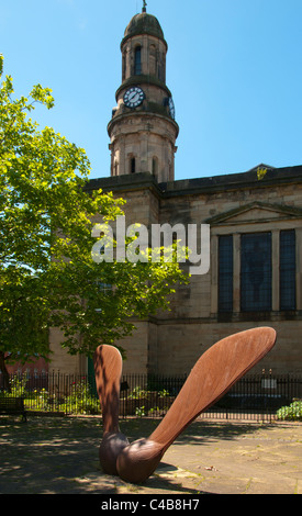 Sycamore Seed, a sculpture by Andrew McKeown. St Phillip's Square, Salford, England, UK. Behind is the Church of St. Philip with St. Stephen. Stock Photo