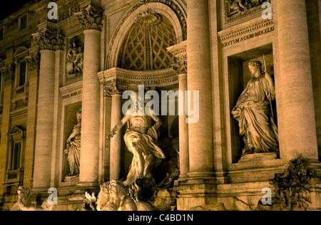 Rome, Italy; Detail of the Fontana di Trevi in the last evening light with the mighty figure of Oceanus, the god of the ocean on a shell shaped chariot in the middle with the statues of abundance and healing left and right respectively Stock Photo