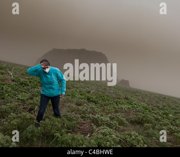 Woman wipes the ash from her eyes from Grimsvotn Volcanic Eruption in the Vatnajokull Glacier, Iceland Stock Photo