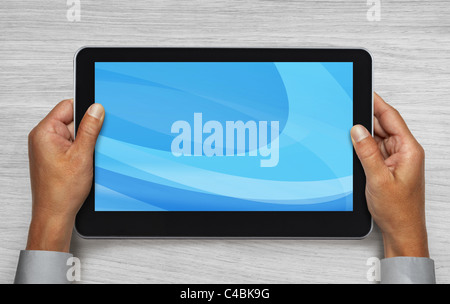hands of businessman holding touchpad pc under table Stock Photo