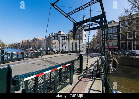 Bridge over the Kloveniersburgwal canal at the end of Staalstraat in the city centre, Amsterdam, Netherlands Stock Photo