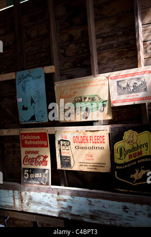 Old Australian advertising signs for sale in a junk shop in Maldon. Stock Photo