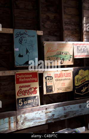 Old Australian advertising signs for sale in a junk shop in Maldon. Stock Photo