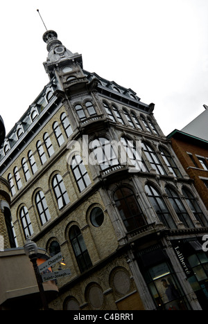 Heritage building at corner of Rue de la Chapelle and St Joseph Laliberte fur shop Saint-Roch district Quebec City in rain Stock Photo