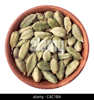 cardamom seeds in a wooden bowl isolated on white Stock Photo