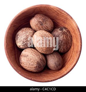 Nutmeg in a wooden bowl isolated on white Stock Photo