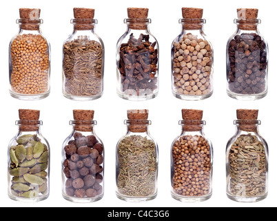 Assortment of different spices in glass bottles isolated on white Stock Photo