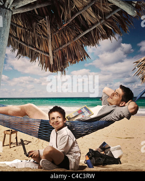 Father and son relaxing on beach