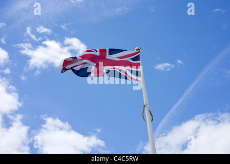 union jack flag flying in the wind on a flagpole union jack flag flying in the wind on a flagpole