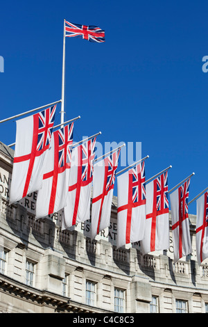 Royal Navy White Ensigns and Union Jack flying above Admiralty Arch along The Mall in London Stock Photo