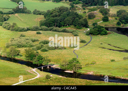 Footbridge over the River Derwent and Cannon Dub, Derwent Water, Cumbria. Stock Photo