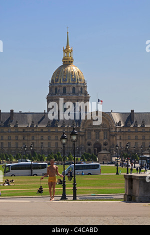 Parisian man exercises in the park with Les Invalides in the background Stock Photo
