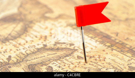 Flag red a pin on old map. Photo closeup. Selective focus Stock Photo