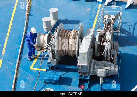 seaman seamen deckhands working work ship winch ropes warps Stock Photo