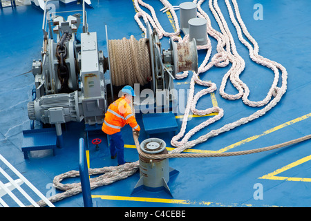 seaman seamen deckhands working work ship winch ropes warps Stock Photo