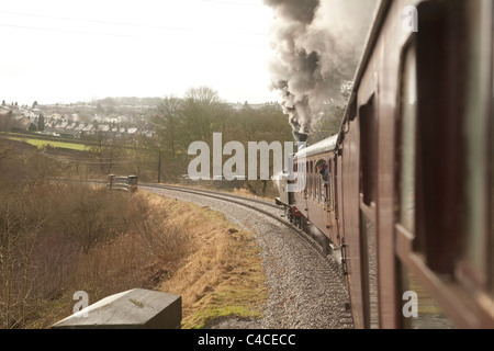 Steam tank locomotive 0-6-2 number 85 in steam and pulling a passenger train on the Keighley and Worth Valley Railway Stock Photo