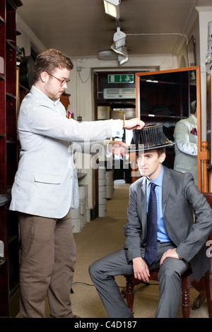 Man with conformateur device on head whilst having head measured for Silk Top Hat at Lock & Co hatters,London.Photo:Jeff Gilbert Stock Photo