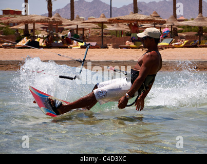 Unidentified man jumps high on kitesurf in Red Sea waters in Egypt, Sharm-El-Sheikh on April 24, 2010 Stock Photo