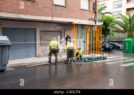 Lorca Spain earthquake building scene. Large destructive earthquake with collapsed buildings and destruction. Workers in helmet. Stock Photo