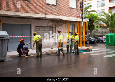 Lorca Spain earthquake building scene. Large destructive earthquake with collapsed buildings and destruction. Workers in helmet. Stock Photo