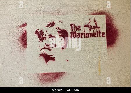 Stencil showing the German politician /  Federal Chancellor Angela Merkel's face with the words The Marionette in Berlin Stock Photo