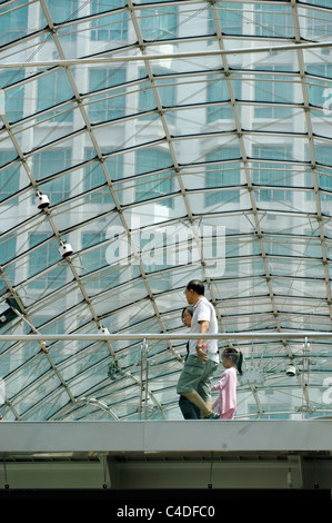 Shoppers under the glass roof of the Bugis Junction shopping mall, Singapore Stock Photo