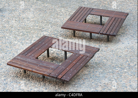 Modern square wooden benches on a cobbled surface at Prague Castle in the Czech Republic Stock Photo