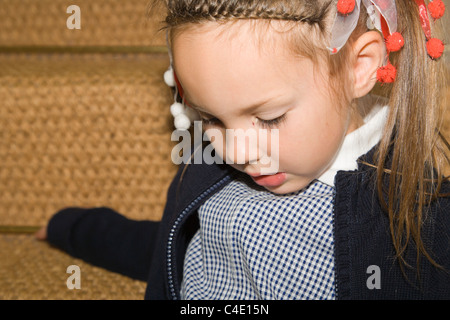 4 years old schoolgirl in gingham dress, summer school uniform Stock Photo