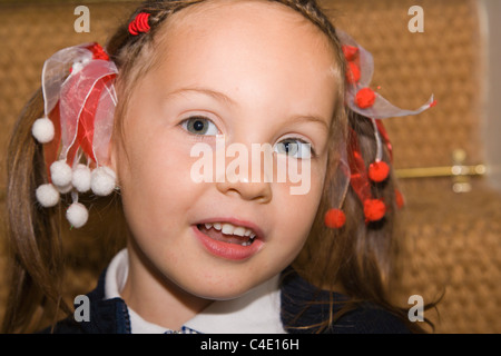 4 years old schoolgirl in gingham dress, summer school uniform Stock Photo