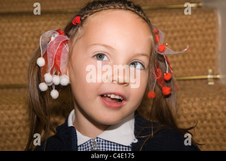 4 years old schoolgirl in gingham dress, summer school uniform Stock Photo