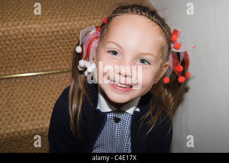 4 years old schoolgirl in gingham dress, summer school uniform Stock Photo