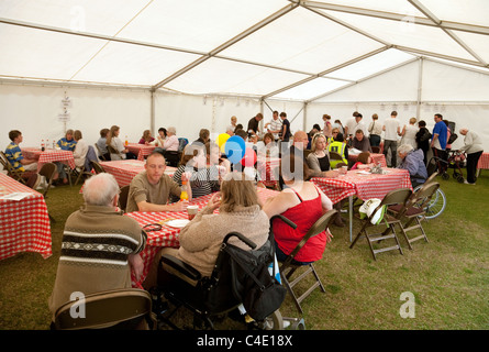 People having afternoon tea in the Tea tent, Newmarket town fair, Newmarket Suffolk UK Stock Photo