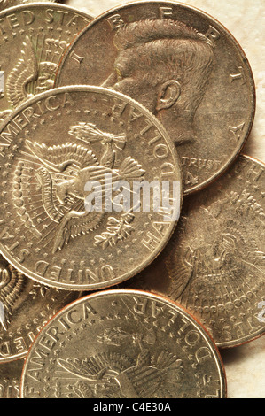A pile of Kennedy half a dollar pieces lays on a table top. Stock Photo
