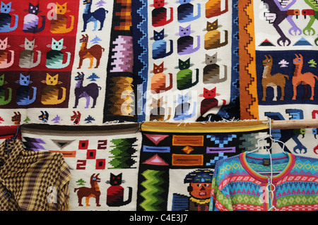 Colourful tapestries for sale on the Market at Pisac in Peru Stock Photo
