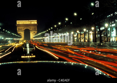 Paris at night. Night time looking along the Champs Elysees towards the Arc de Triomphe. Stock Photo