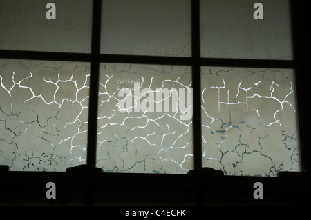 Oddly cracked patterns in frosted bathroom window Florida Stock Photo