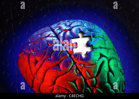 Piece missing from a jigsaw puzzle made from a photo of a human (model) brain. Stock Photo