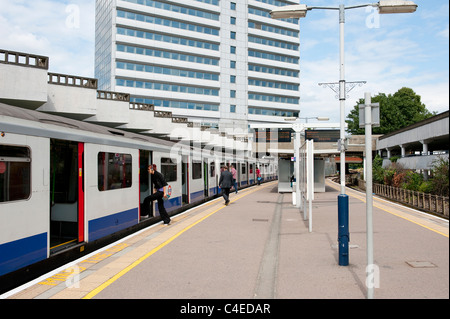 Passengers boarding a London Underground train at an overground station on the District Line, London. Stock Photo