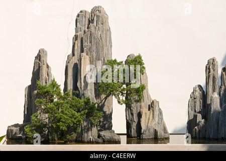 Miniature landscape with rock formations that simulate mountain peaks and accompanied by a suggestion of forest. Suzhou, China Stock Photo