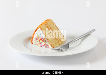 A slice of sponge cake on a white plate with a fork (for version without a fork - ref C4EHA8) Stock Photo