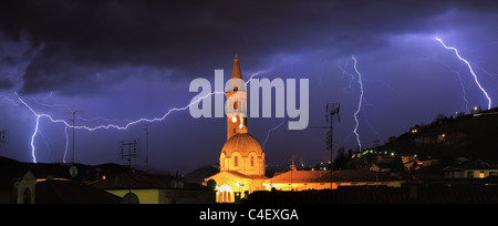 Panoramic view on lightning over Alba and surrounding hills during thunderstorm in northern Italy. Stock Photo