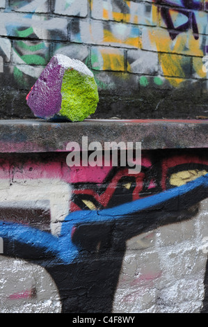 Graffiti on stone wall and painted stone Stock Photo